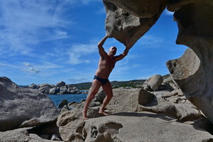 Catalan muscle bear in the rocks at the beach